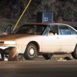 Investigators search a car at the scene of a police involved shooting on Wednesday in Falcon Heights, Minnesota. A Minnesota officer fatally shot a man in the car with a woman and a child, an official said. (Leila Navidi/Star Tribune via AP)