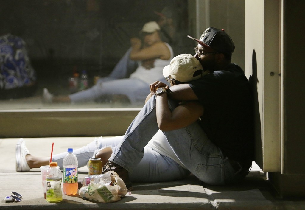 People wait to return to their cars early as police investigate the scene of Thursday&rsquo;s shooting, on Friday, in Dallas. (Mark Mulligan/Houston Chronicle via AP)