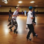 Michael Cameron (center left), of Bellevue, laughs with Sam Nelson, of Snohomish, as they skate a few laps to cool down from practicing their skate dance moves at Lynnwood Bowl and Skate on Thursday. (Ian Terry / The Herald)