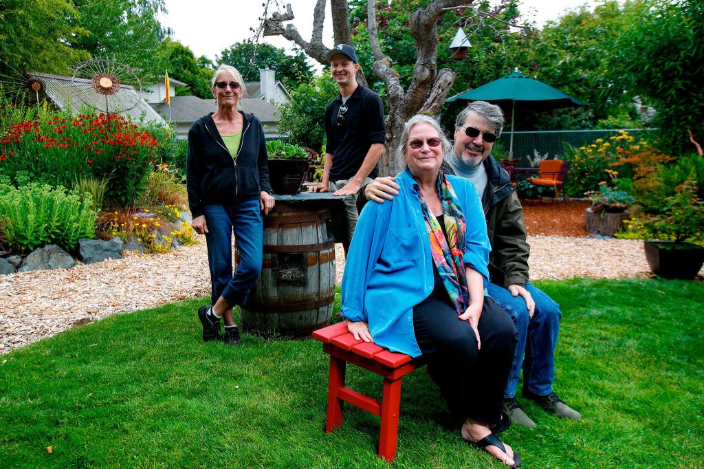 Gardeners Kristine Kishida (left) and Peter Everill help keep in shape the artistic gardens of Deb Taylor and Ken Morrison, whose home is part of the Edmonds in Bloom Garden Tour. (Andy Bronson / The Herald)