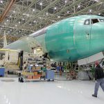 A Boeing Co. employee walks past a Boeing 767 under assembly in February 2011. (Ted Warren / Associated Press)
