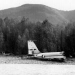 The tail section of a Boeing 707 sits on a sandbar in the North Fork Stillaguamish River on Oct. 19, 1959, after the plane crashed and broke apart. Four of eight people on the plane were killed. (Ron Palmer)