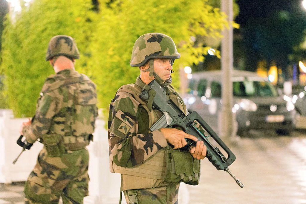 Soldiers stand guard by a sealed off area after a truck drove onto the sidewalk and plowed into a crowd of revelers in the French resort city of Nice on Friday. (AP Photo/Ciaran Fahey)