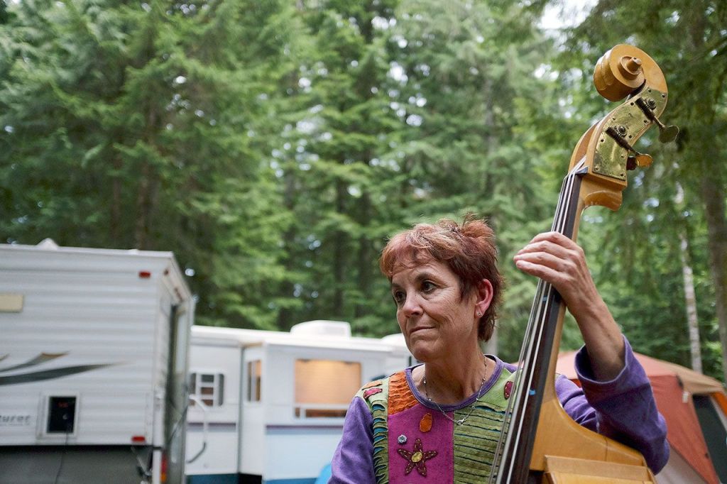 Laurie McNabb, of Lakewood, plays the bass during a jam session in the campground, during the Darrington Bluegrass Festival in 2014. (Herald file photo)