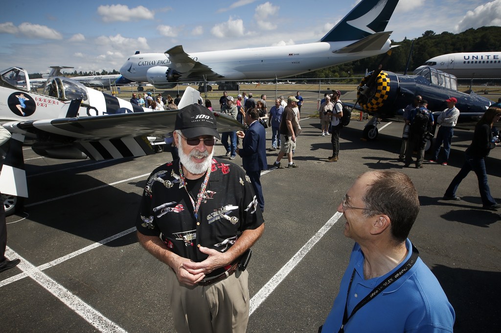 Jim Reed (left), of Seattle, chats with David Nestvold during the first day of the company&rsquo;s centennial celebration at Boeing Field in Seattle on Friday, July 15, 2016. &ldquo;I&rsquo;ve worked here for half of the life of Boeing,&rdquo; Reed said. (Ian Terry / The Herald)