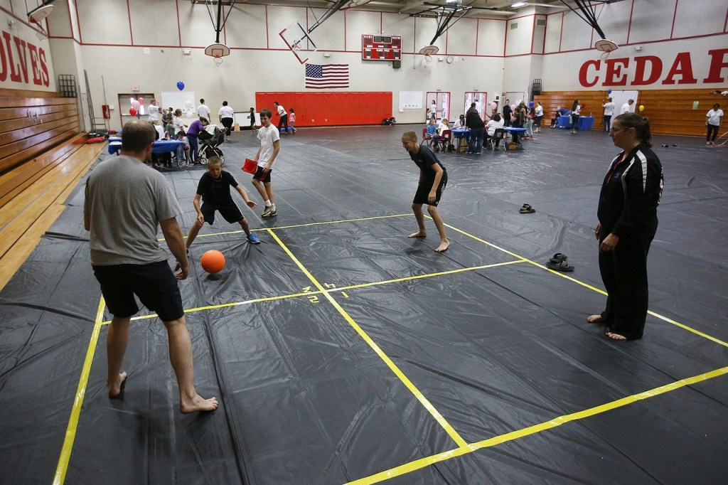 The Weeks family, of Marysville, plays 4-square at a family event put on by the new Marysville Community Church on July 9. (Ian Terry / The Herald)