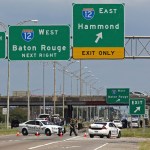 Baton Rouge police block Airline Highway after police were shot in Baton Rouge, Louisiana, on Sunday. Authorities in Louisiana say several law enforcement officers are dead, and several injured. (AP Photo/Max Becherer)