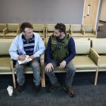 Snohomish County social worker Jesse Calliham (right) helps Jared Gans, of Everett, get started on his paperwork prior to a chemical dependency evaluation at Evergreen Recovery Center in Everett on June 29. Snohomish County Sheriff Ty Trenary has vowed to allocate funds received from a potential 0.2 percent sales-tax increase to further expand the embedded social worker program that Calliham is a part of. (Ian Terry / The Herald)