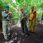 Crew leader Sachiko Flores (left) explains how to build a trail to deaf members of the Northwest Youth Corps at Ebey&rsquo;s Landing National Historical Reserve. Youth crew members Niko (center), Drew and Bryson spent the week with other deaf crew building a new trail into a loop. (Andy Bronson / The Herald)