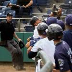 AquaSox catcher Johan Quevedo (center) makes a catch as his teammates watch during their 8-6 loss to the Tri-City Dust Devils on Tuesday at Everett Memorial Stadium. (Andy Bronson / The Herald )