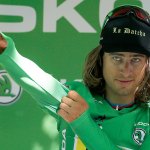 Peter Sagan of Slovakia puts on the best sprinter&rsquo;s green jersey on the podium after winning the 16th stage of the Tour de France Monday. (AP Photo/Peter Dejong)