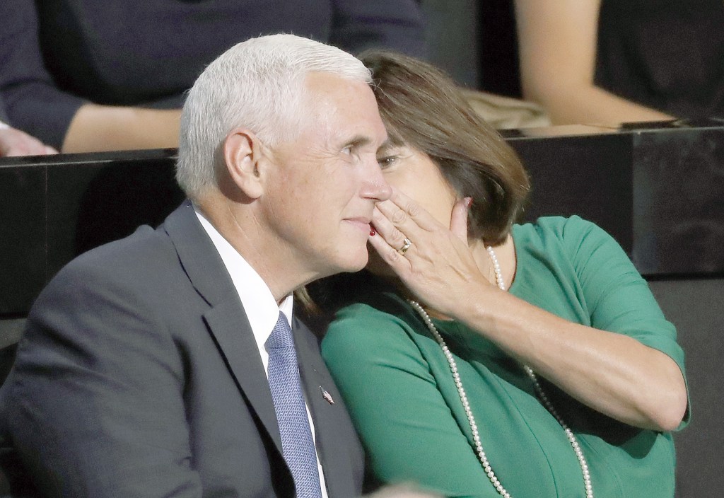 Paul Sancya / associated press                                Karen Pence speaks to her husband, Republican vice presidential candidate Mike Pence, at the convention Monday.