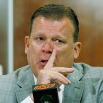 Oklahoma State basketball coach Brad Underwood fights back tears at a news conference in Stillwater, Okla., Friday, after announcing that Cowboys player Tyrek Coger died after a 40-minute team workout on the football stadium stairs in hot weather on Thursday. (AP Photo/Sue Ogrocki)