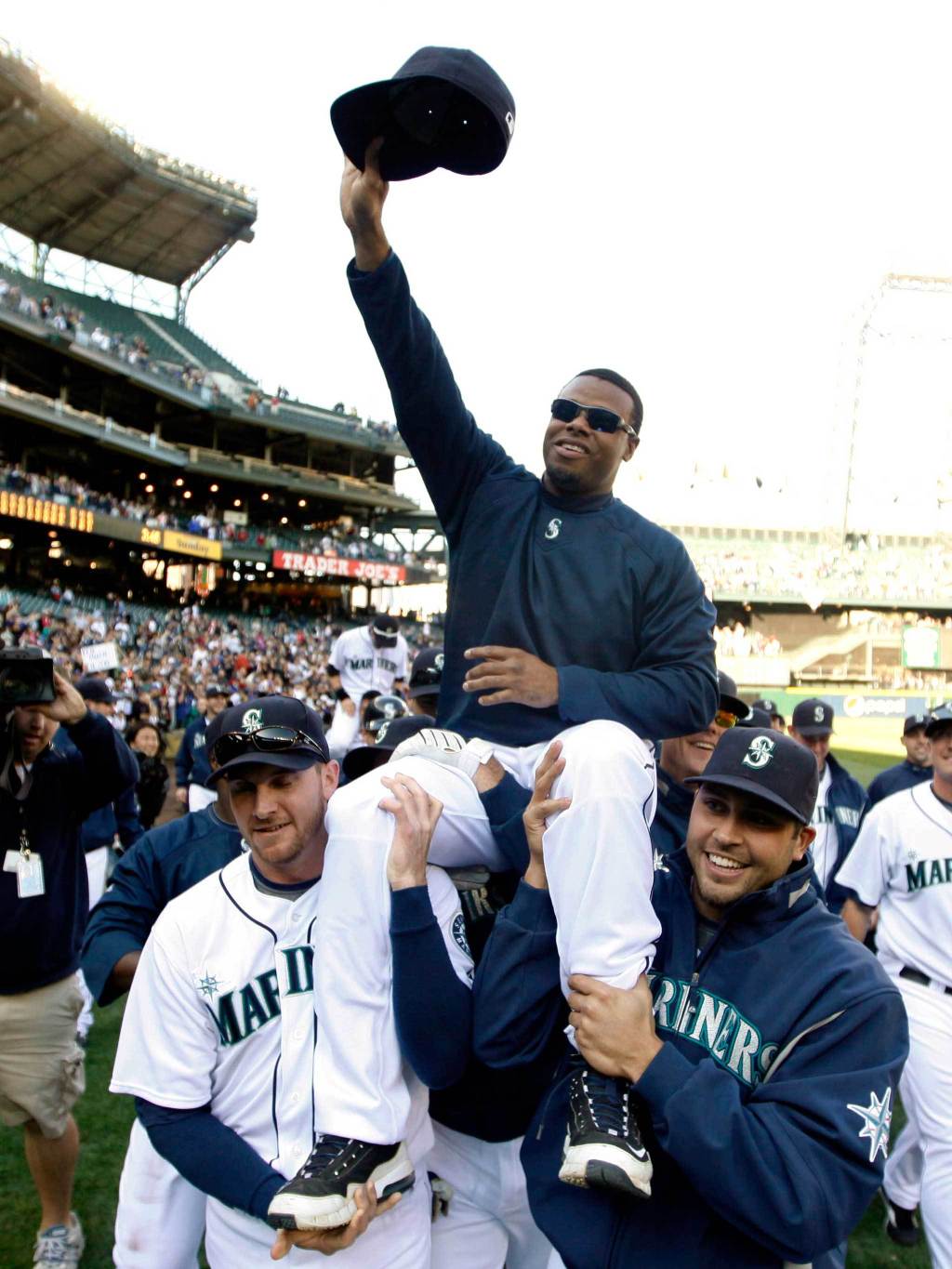 In this Oct. 4, 2009, photo, Seattle Mariners&rsquo; Ken Griffey Jr. is carried around the field by teammates Ryan Langerhans, left, and Matt Tuiasosopo, right, after a win over the Texas Rangers in a baseball game in Seattle. (AP Photo/John Froschauer, file)
