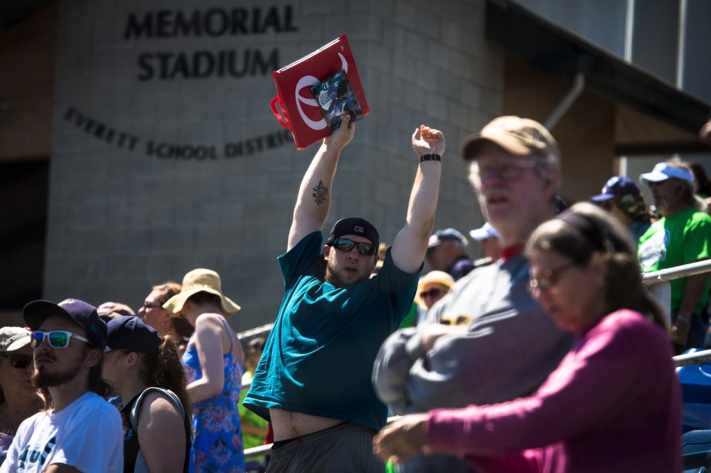 A fan stretches in the seventh-inning stretch during Wednesday&rsquo;s game against the Vancouver Canadians before 4,379 fans on Kidճ Day at Everett Memorial Stadium.(Daniella Beccaria / For the Herald)