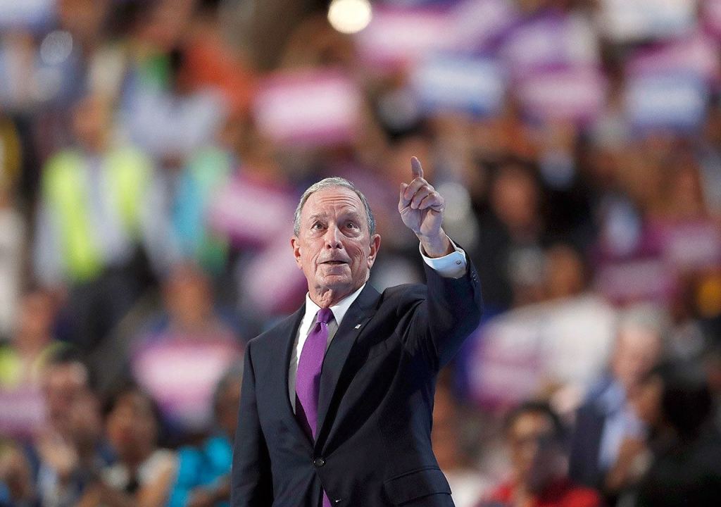 Former New York Mayor Michael Bloomberg leaves the stage after speaking Wednesday. (AP Photo/Paul Sancya)