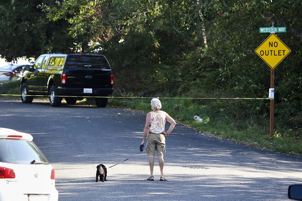 Crime scene tape blocks the road at the intersection of 64th Place West and Webster Way in Mukilteo following a shooting that left three dead and one injured at a home early Saturday morning. One suspect was apprehended hours later in Lewis County. (Ian Terry / The Herald)
