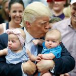 Republican presidential candidate Donald Trump kisses babies during a campaign rally Friday in Colorado Springs, Colorado. (AP Photo/Evan Vucci)