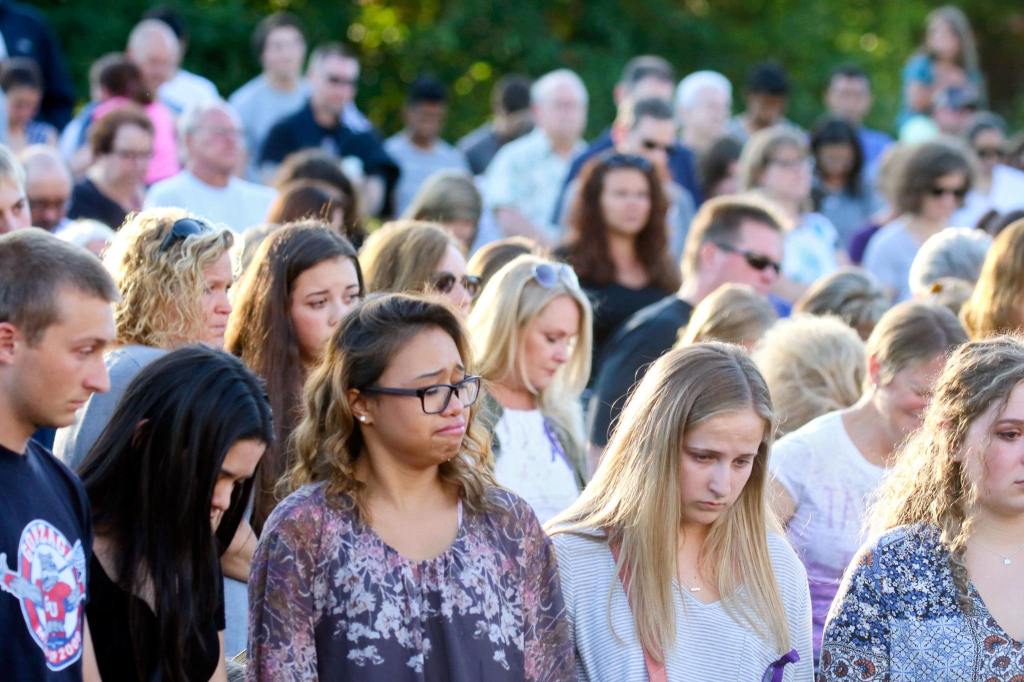 Hundreds of mourners gather at the vigil for the slain Sunday night. (Kevin Clark / The Herald)