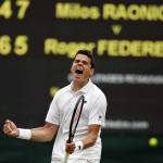 Milos Raonic celebrates after beating Roger Federer in their Wimbledon men&rsquo;s semifinal singles match on Friday in London. (AP Photo/Alastair Grant)