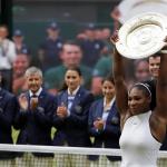 Serena Williams raises the trophy after beating Angelique Kerber in the Wimbledon women&rsquo;s singles final on Saturday in London. It is Williams&rsquo; 22nd major championship, tying her with Steffi Graf for tops in the Open era. (AP Photo/Ben Curtis)