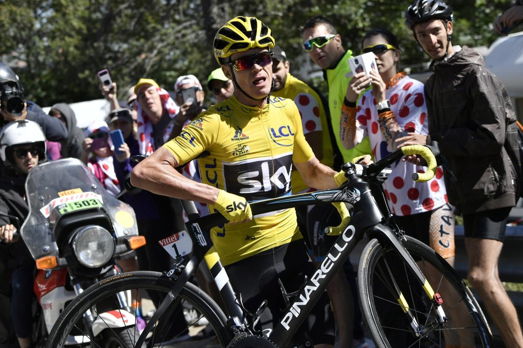 Britain&rsquo;s Chris Froome, wearing the overall leader&rsquo;s yellow jersey, runs with his bike after a crash at the end of the twelfth stage of the Tour de France on Thursday near Mont Ventoux, France. (Jeff Pachoud/ Pool Photo via AP)