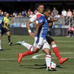 L.A. Galaxy midfielder Giovani Dos Santos (front) takes a shot on goal against Arsenal during the first half of the MLS All-Star game Thursday in San Jose, Calif. (AP Photo/Marcio Jose Sanchez)
