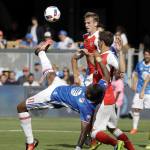 Montreal Impact forward Didier Drogba (left) tries a scissors kick against two Arsenal defenders during the first half of the MLS All-Star game Thursday in San Jose, Calif. (AP Photo/Marcio Jose Sanchez)