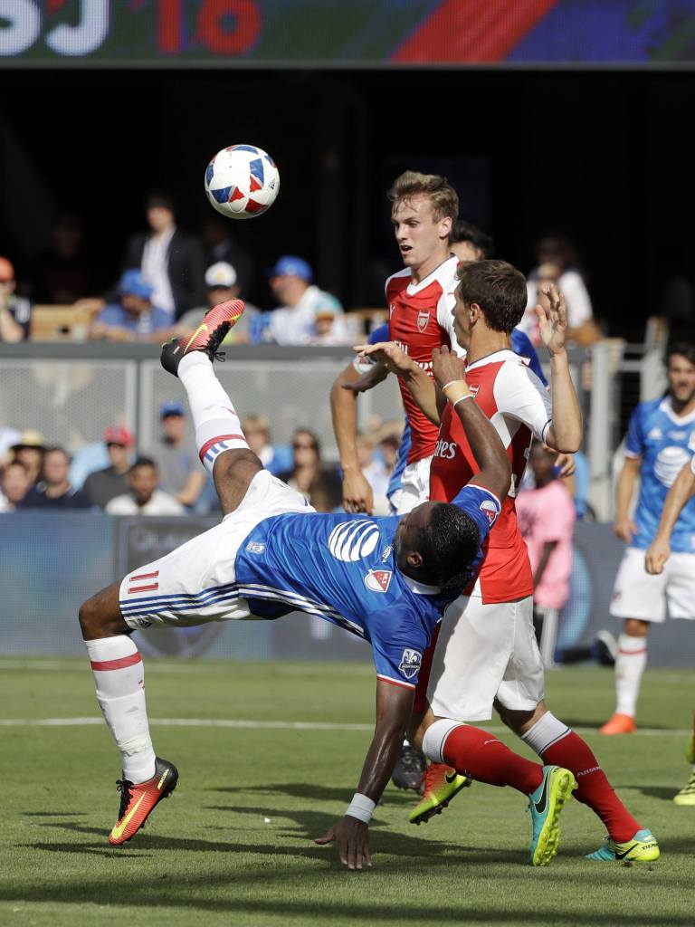 Montreal Impact forward Didier Drogba (left) tries a scissors kick against two Arsenal defenders during the first half of the MLS All-Star game Thursday in San Jose, Calif. (AP Photo/Marcio Jose Sanchez)