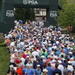 Fans leave the course during a weather delay in the third round of the PGA Championship at Baltusrol Golf Club in Springfield, N.J. on Saturday. (AP Photo/Mike Groll)