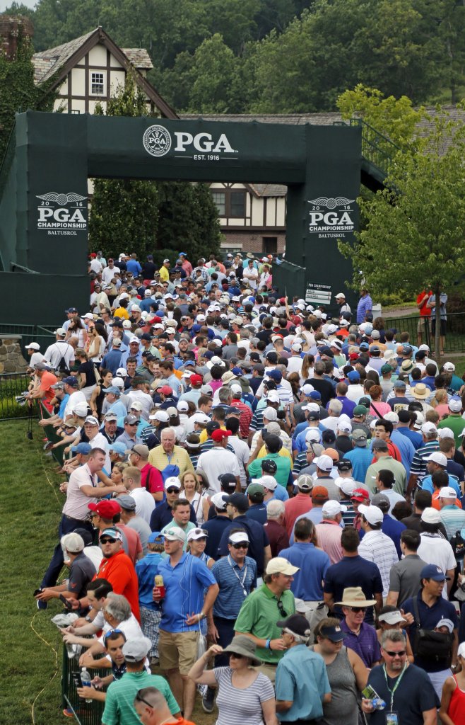 Fans leave the course during a weather delay in the third round of the PGA Championship at Baltusrol Golf Club in Springfield, N.J. on Saturday. (AP Photo/Mike Groll)