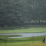A couple looks over the 18th fairway during a weather delay in the third round of the PGA Championship at Baltusrol Golf Club in Springfield, N.J. on Saturday. (AP Photo/Seth Wenig)