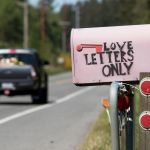 A truck passes by a pink &ldquo;Love Letters Only&rdquo; mailbox on Highway 525 on Whidbey Island near Greenbank. The pink mailbox is owned by Stacy Anderson, who lives down a lane off the highway. People don&rsquo;t know who it belongs to but leave letters in the box on whatever they feel like expressing. She saves every letter.