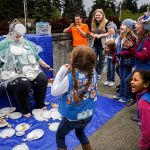 Fellow Girl Scout Daisies react when Payton Camacho&rsquo;s whip cream pie toss lands right on troop leader Tina Fish&rsquo;s face Thursday night in the parking lot outside New Life Church in Everett.