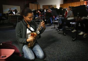 North Middle School seventh-grader Hannah Wells, who plays clarinet, admiringly studies a school saxophone while helping clean the school instruments before summer break.