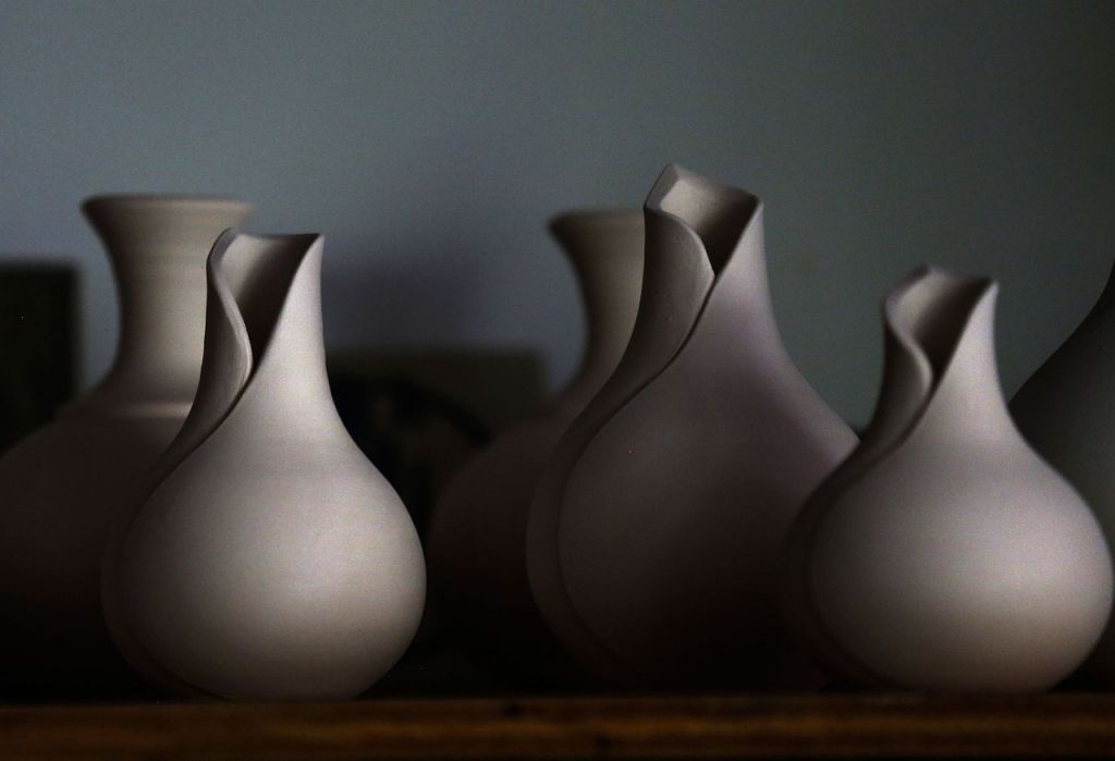 Stem vases and others line shelves in Marguerite Goff&rsquo;s studio.