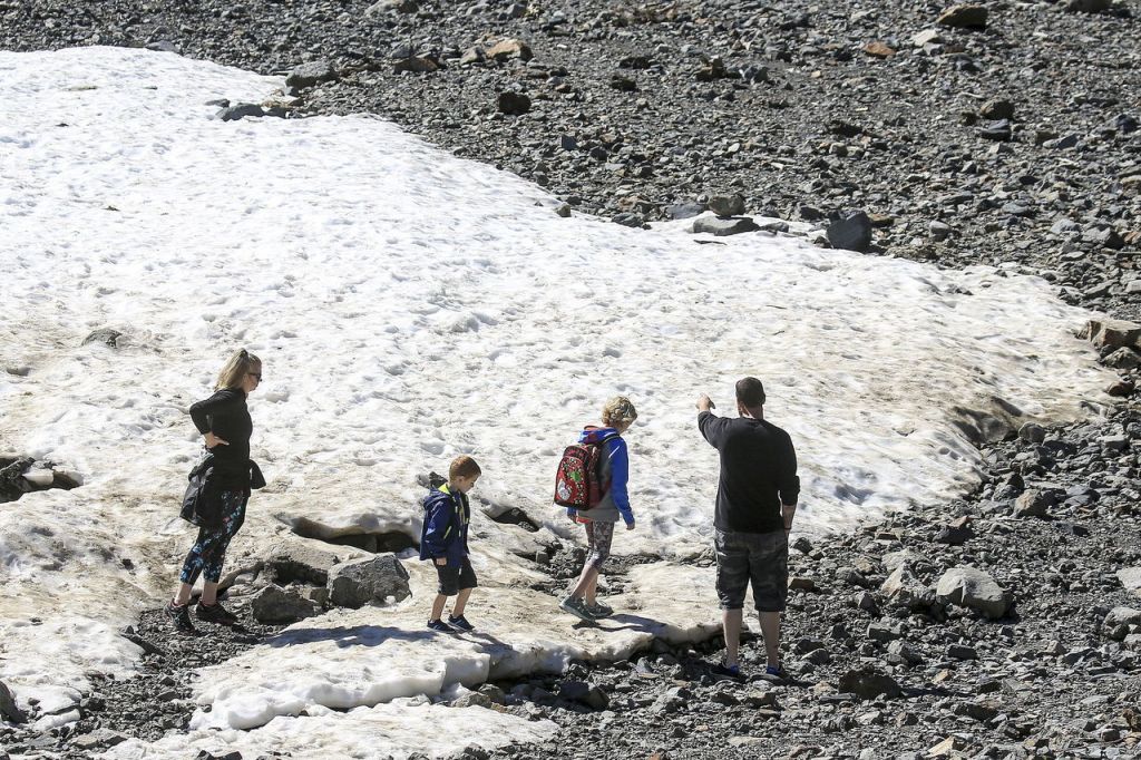 A family plays in the snow Sunday morning at the Big Four Ice Caves east of Granite Falls.