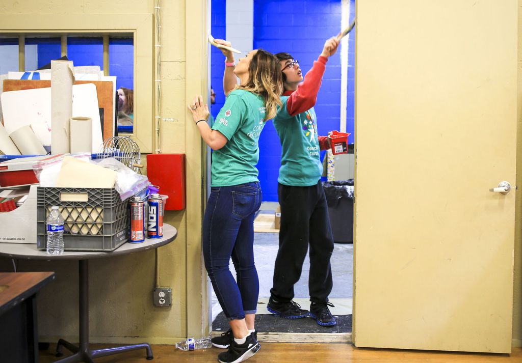 Jenna Sanders, left, and Mark West paint Saturday morning at the Marysville Boys & Girls Club on April 30, 2016. More than 250 local Comcast employees volunteered their day to paint, clean, landscape, organize and repair the center that host more than 800 kids a year.