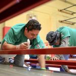 Alex Contreras (left) and Tony Perez clean bleachers Saturday morning at the Marysville Boys & Girls Club.