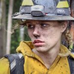Shayla Adkins takes a breather at the scene of the fire. The cause of the blaze has yet to be determined.