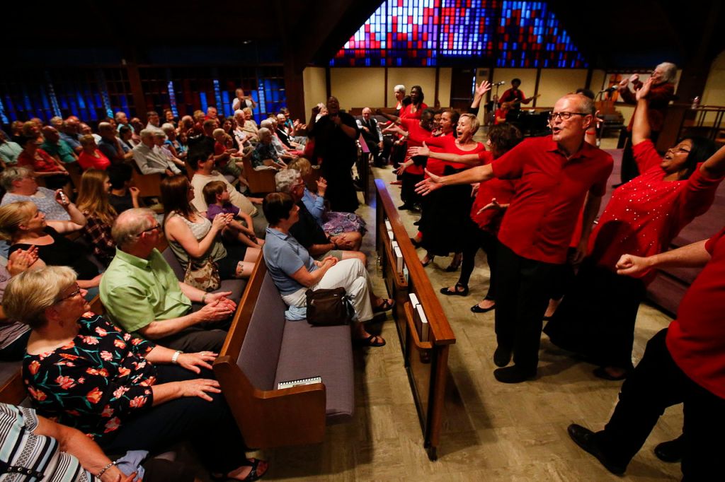 Randy Thomas (right), a member of the Total Experience Gospel Choir, sings as he reaches out his arm toward attendants of the First Presbyterian Church of Snohomish&rsquo;s 140 year celebration on Friday. Hundreds gathered to kickoff the church&rsquo;s renewal weekend, which includes activities and prayer groups.