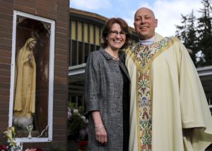 Karin McMicheal with her husband, the Rev. Tom McMichael, at St. Mary&rsquo;s Catholic Church in Marysville. McMichael converted from the Lutheran Church and has served St. Mary&rsquo;s for a year.