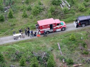 Law enforcement officials gather evidence Tuesday, northwest of Oso, where human remains were found.