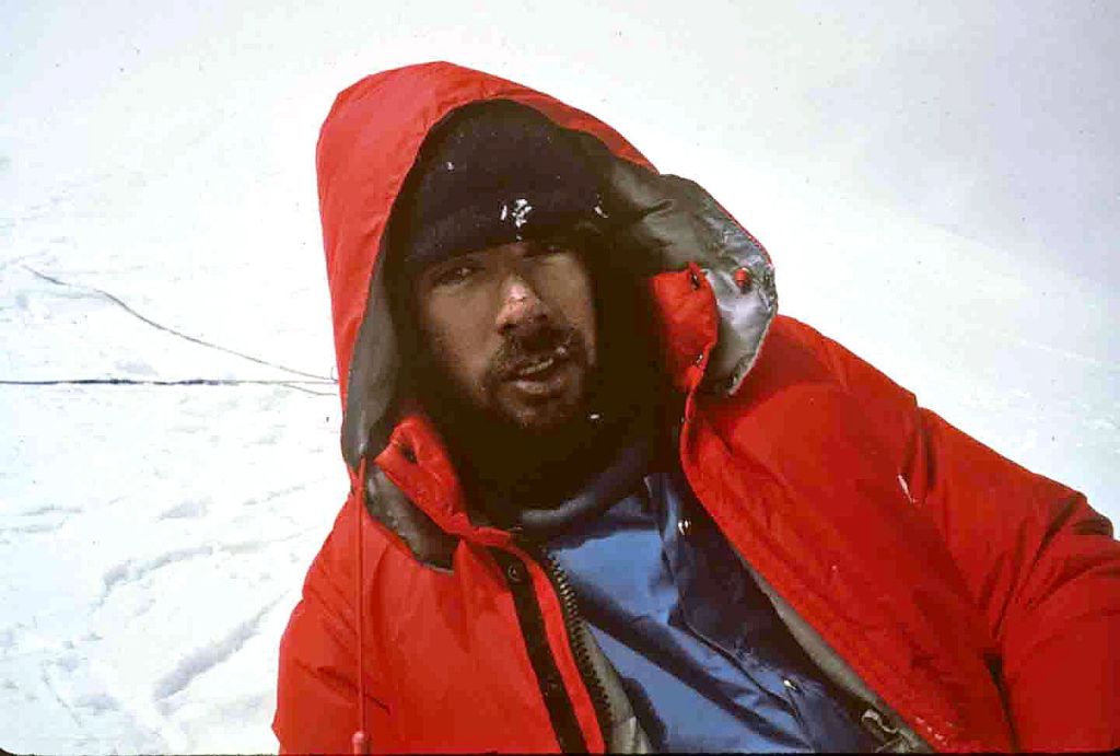 An ailing Simon McCartney rests during the descent on Cassin Ridge.