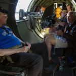 As the plane shakes, B-17 bomber veteran &ldquo;JW&rdquo; Roundhill (right) explains what goes on during takeoff to his son, Barry, during flight in the Aluminum Overcast.