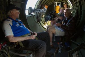 As the plane shakes, B-17 bomber veteran &ldquo;JW&rdquo; Roundhill (right) explains what goes on during takeoff to his son, Barry, during flight in the Aluminum Overcast.