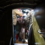 Climbing out from the nose of the Aluminum Overcast, B-17 navigator retired Lt. Col. Ken Wheeler gets and returns a salute from the Experimental Aircraft Association&rsquo;s Terry Tucker (left) during a flight Monday from Boeing Field in Seattle. Thirteen veterans, who fought WWII in B-17s, met for a D-Day reunion and many took a flight over Seattle in the bomber.