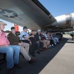 A dozen B-17 bomber veterans sit under the Aluminum Overcast&rsquo;s wing.