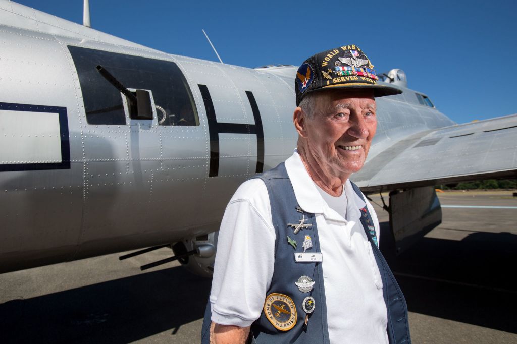 B-17 bomber veteran Arthur Unruh stands in front of his waist gunner position next to the Experimental Aircraft Association&rsquo;s Aluminum Overcast bomber Monday at Boeing Field in Seattle. Unruh and 12 other vets, who fought WWII in B-17s, met at the Museum of Flight for a D-Day reunion.