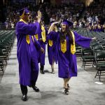 Brittney Wood (right) gives fellow graduate Braden Ash a high-five as the Lake Stevens High School Class of 2016 takes to the floor for the start of their graduation ceremony at Xfinity Arena in Everett on Tuesday, June 7, 2016. Photo taken on 06072016